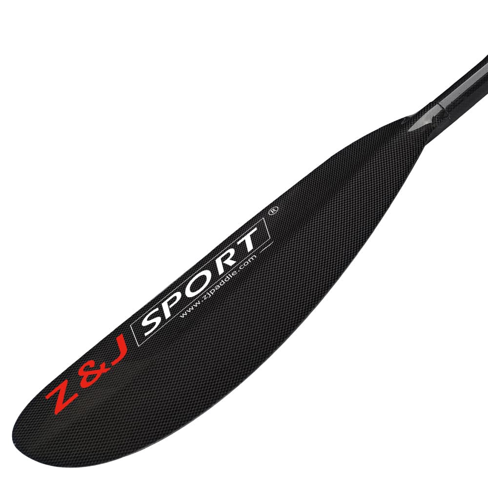 Close-up of a ZJ SPORT black carbon fiber kayak paddle blade from the ZJ 2 piece/4 piece High-Angle Dynamic Blade (SKD-I), featuring sleek, elongated, asymmetrical design with textured surface, ideal for long-distance paddling. The Z&J SPORT text appears in red and white on plain white background.