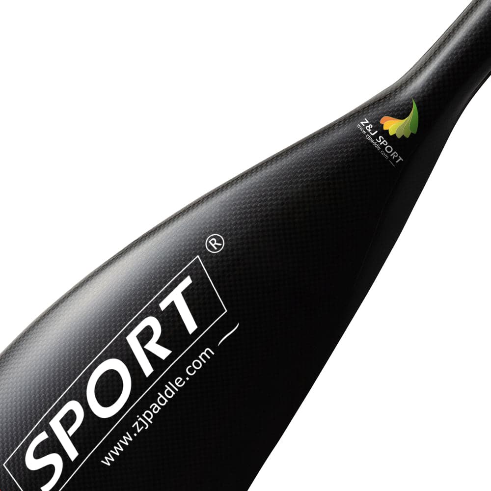 The ZJ Separate Blade With Round Hollow Spigot, a sleek black carbon fiber kayak paddle blade, is ideal for enhancing kayaking strokes. The white text Z&J SPORT and www.zjpaddle.com is prominent, accompanied by a leaf logo on the top edge.