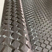 A close-up shows the ZJ SPORT New Black 3K Carbon Fiber Fabric, 1m x 5m, featuring a diamond-shaped pattern with a reflective and textured surface resembling metallic cloth, expertly packed to emphasize its sleek and modern design.