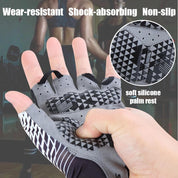 A close-up of a hand wearing Z&J SPORT UV Protection Fingerless Breathable Outdoor Rowing, Kayaking, Paddling Gloves. The gray design features black geometric patterns with a soft silicone palm rest for wear-resistance, shock absorption, and non-slip grip. Blurred gym scene in the background.