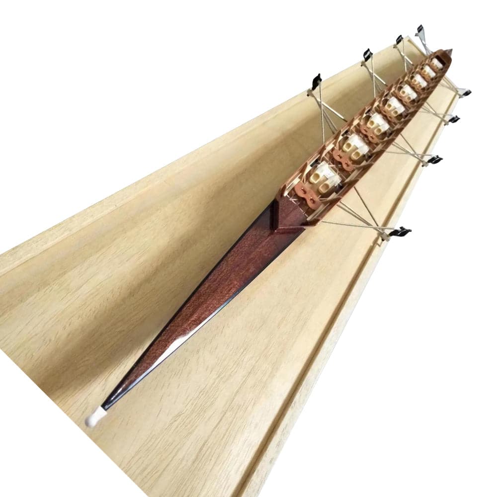 The ZJ Handcrafted Rowing Boat Model Miniature by zijie is showcased on a flat, light surface. Resembling classic canoes, it features intricate details with oars on both sides and visible seats and structures inside.