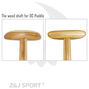 Two close-up images show the ZJ SPORT Hybrid Outrigger Canoe Steering Paddles wooden shaft. The left image presents a front view, while the right displays a side view, highlighting the smooth wood grain. Above, text states Handcrafted wood shaft for waka ama paddles.