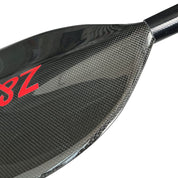 A close-up of the ZJ SPORT Full Carbon Fiber Flatwater Canoe Paddle showcases a glossy, woven texture on the blade, with 3Z in red on the upper left side.