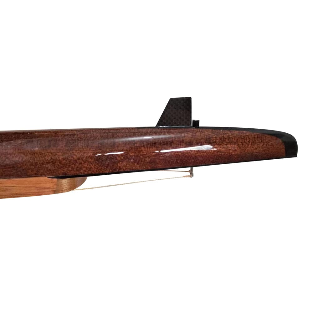 A close-up of a sleek, brown model airplane wing with a black fin, its shiny surface mimics the polished wood craftsmanship found in ZJ Handcrafted Rowing Boat Model Miniatures by zijie. The background is plain white.