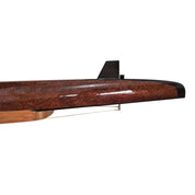 A close-up of a sleek, brown model airplane wing with a black fin, its shiny surface mimics the polished wood craftsmanship found in ZJ Handcrafted Rowing Boat Model Miniatures by zijie. The background is plain white.