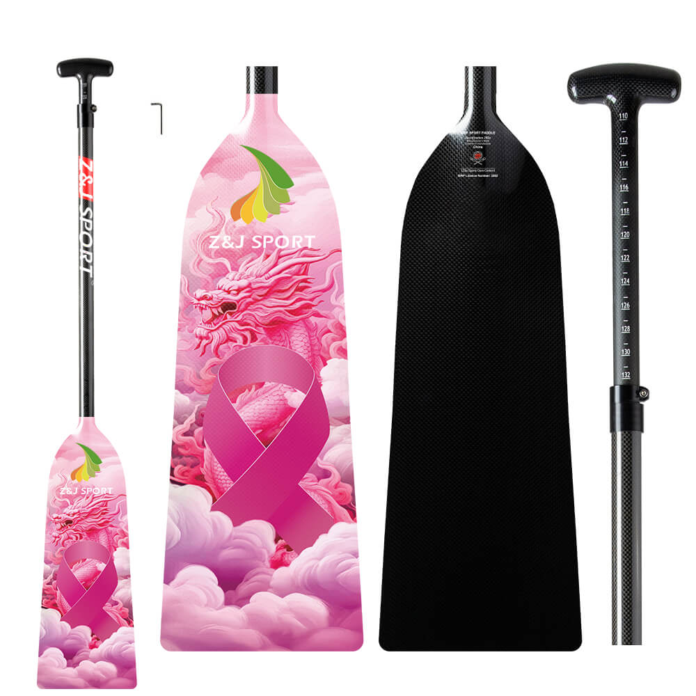The ZJ SPORT IDBF Approved Carbon PINK Series Dragon Boat Paddle features adjustable lengths, a pink dragon and cloud design with a pink ribbon symbol on the carbon fiber blades, and handles with measurement markings and textured grips.