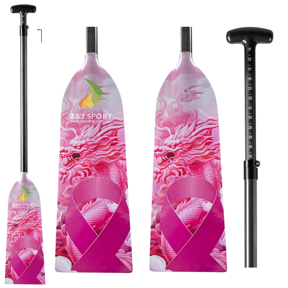 The image depicts the ZJ IDBF Approved Carbon PINK2 Dragon Boat Paddle by ZJ SPORT, featuring dual-sided pink dragon graphics and a ribbon symbol. The paddles have adjustable shafts with measuring scales for customizable lengths and T-shaped grips.