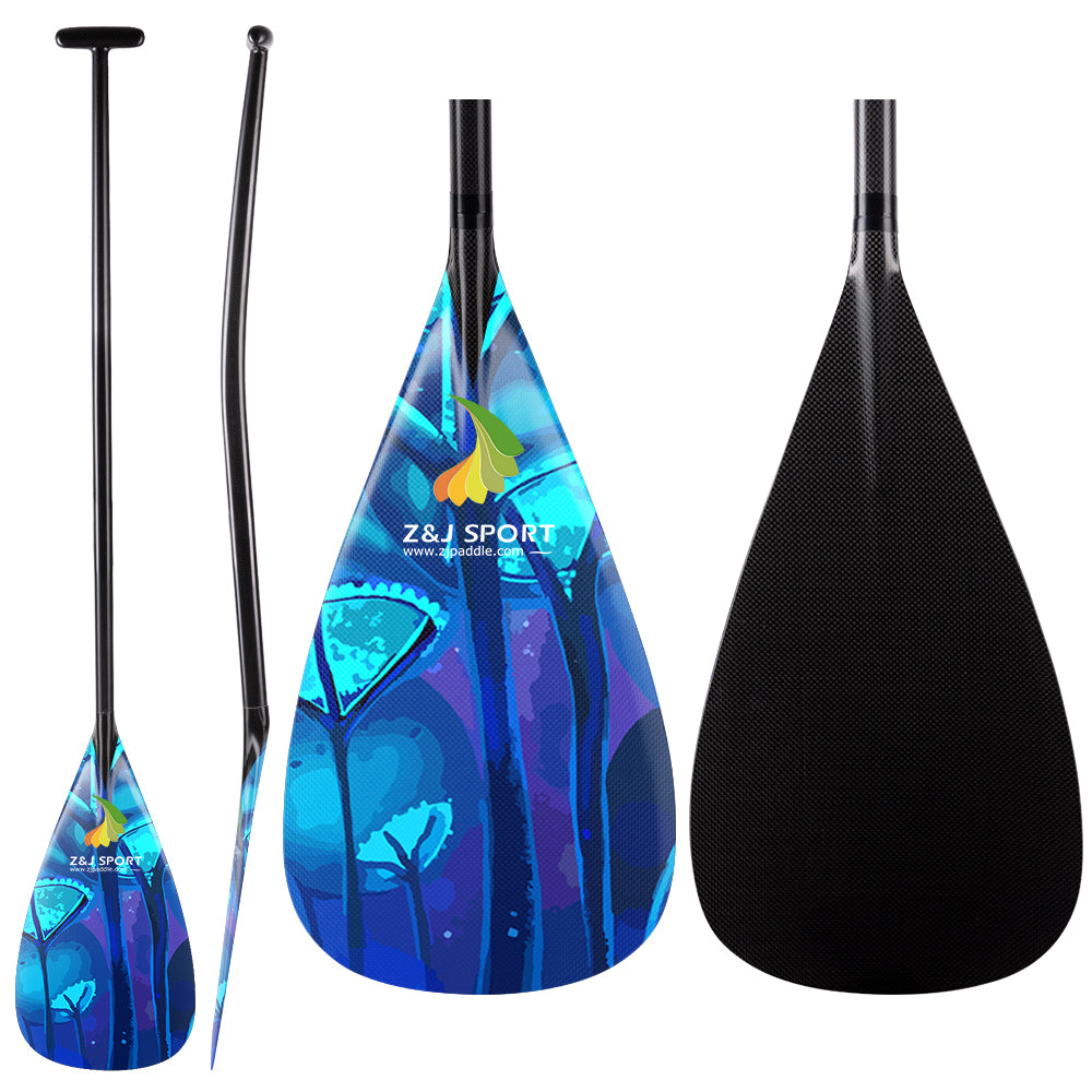 Three views of the ZJ Factory Second Hybrid Carbon Outrigger Canoe Paddle: side, angled, and front. Real photos highlight a blue floral design with a logo and website. The sleek black shaft may have minor imperfections but meets performance specifications for VAA WAKA.