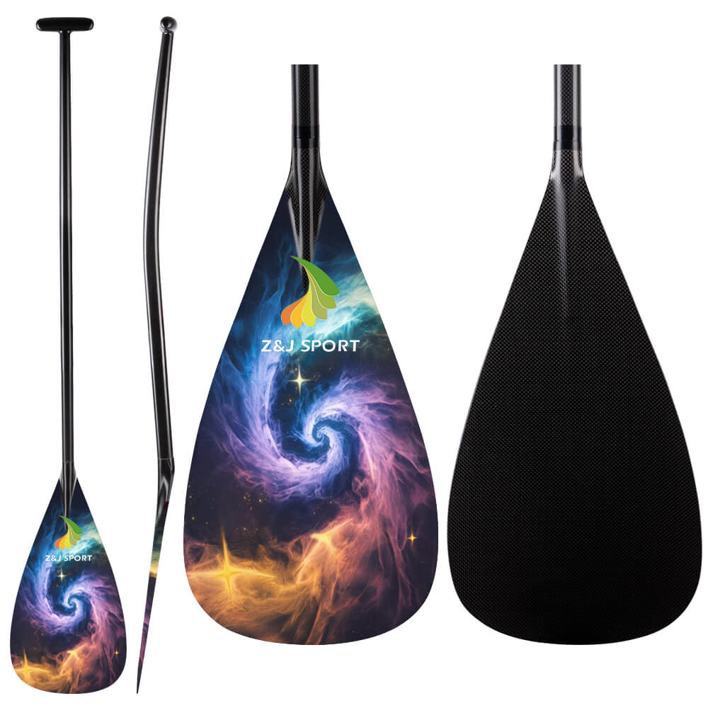 The ZJ Full Carbon Outrigger Canoe VAA Paddle by ZJ SPORT features a cosmic swirl design with vibrant galaxy colors on the front and a textured black back. An ergonomic T-handle provides comfort, with angled, front, and back views highlighting the paddles design.