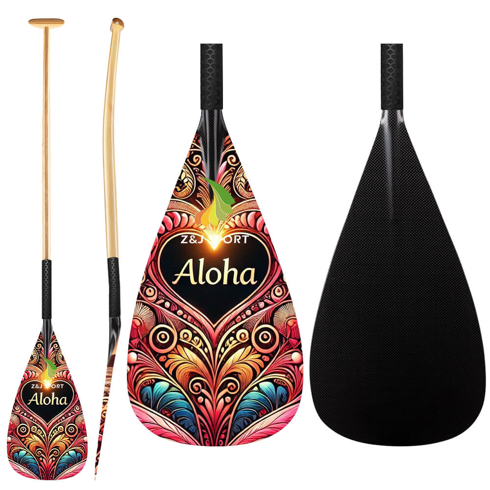 Three colorful ZJ SPORT Hybrid Outrigger Canoe VAA paddles are displayed. Two have ornate patterns, one reading Aloha, all featuring ergonomic T-handles. One paddle shows a solid black back with a wooden shaft contrasting its sleek carbon blade design and anti-skid grip.