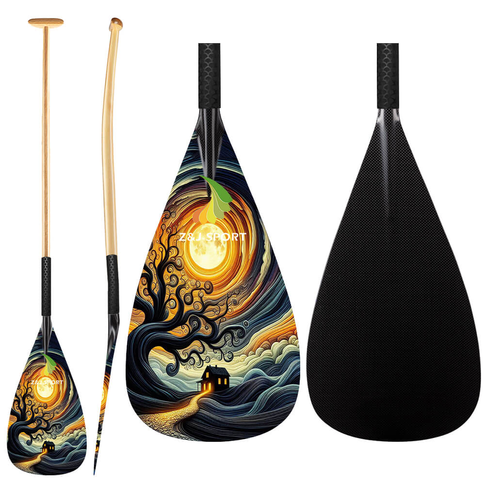 The ZJ SPORT Hybrid Outrigger Canoe VAA Paddle set features a vivid swirling night sky design with a glowing moon and silhouetted tree on the carbon blade, and an ergonomic T-handle with anti-skid grip for comfort.