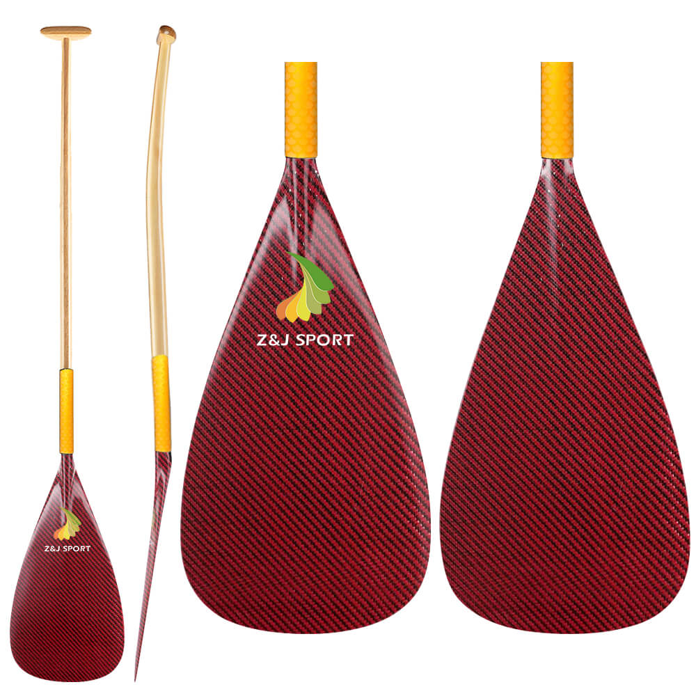 Two red ZJ SPORT carbon fiber paddles with yellow handles and fiberglass shafts are featured. One paddle is shown vertically, while the other side view displays blade curvature. The Z&J SPORT logo is centered on each carbon blade of the ZJ New Hybrid Outrigger Canoe Paddle.