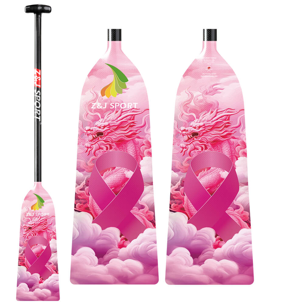 A vibrant pink dragon boat paddle features a striking dragon, clouds, and pink ribbon design with ZJ SPORT text. Its designed as an adjustable length paddle from the ZJ IDBF Approved Carbon PINK Series.