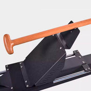 A close-up of the Gym Fitness Equipment Heavy Duty Rowing Machine by zijie shows a sleek black sled-like design with a wooden handle, inclined footrest, and metal rails for smooth movement. Perfect for strength training and fitness exercises.