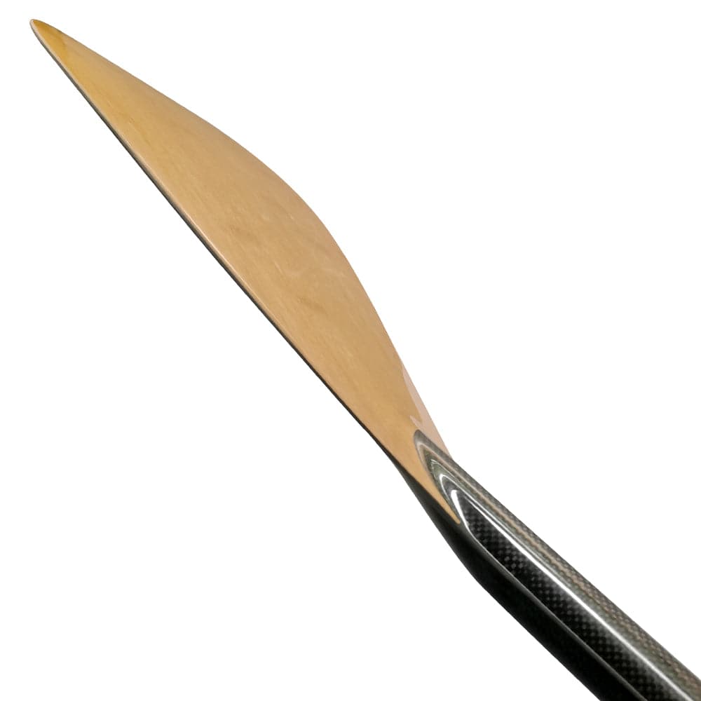 Close-up of a sleek ZJ SPORT Adjustable Carbon Outrigger Canoe Paddle for kids, with a sharp C-SM carbon blade and textured dark handle, resembling a chefs knife. Positioned diagonally with the tip pointing upward against a white background.