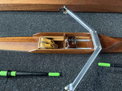 The ZJ Handcrafted Wooden Rowing Boat Model by zijie resembles classic canoes with two detailed seats and footrests. It includes oars with green handles, all presented on a black, textured surface.