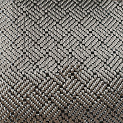 A close-up view of ZJ SPORTs New Black 3K Carbon Fiber Fabric (1m*5m) reveals a textured surface with interlocking rectangular shapes, reminiscent of intricately woven carbon cloth. The uniform 3D metallic appearance offers depth and complexity, akin to precise packing.