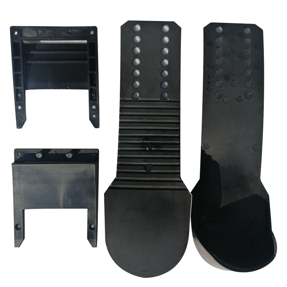 Four ZJ Rowing Shoes Holders by ZJ SPORT, designed like sturdy rowing shoes, feature black plastic car lift pads: two with square bases and rectangular openings, and two elongated with textured surfaces and circular indentations. Free shipping included.