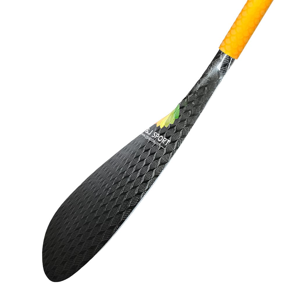 A close-up of the ZJ SPORT ZJ New Hybrid Outrigger Canoe Paddle features a carbon blade with a textured pattern and small logo, combined with an orange-tinted fiberglass shaft and textured grip, all against a plain white background.
